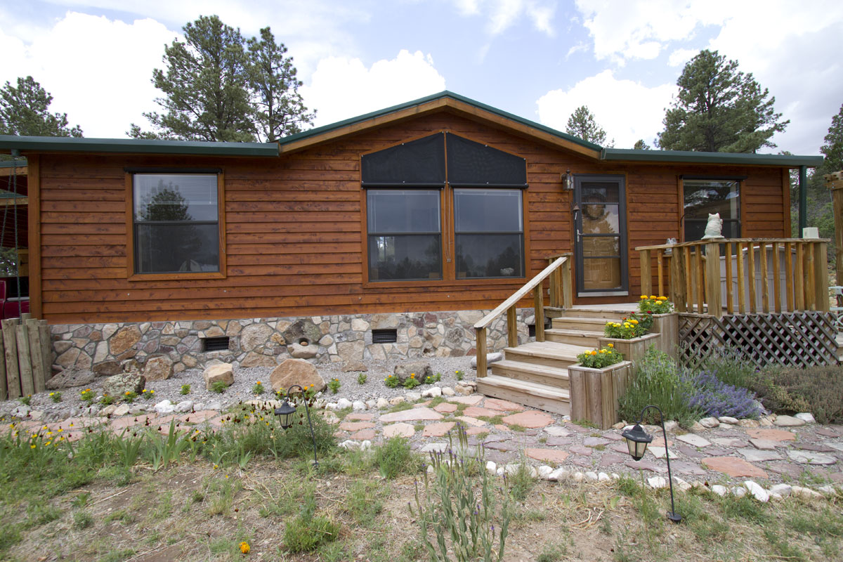 Front of home with planters. Also custom exterior sun shades for six 